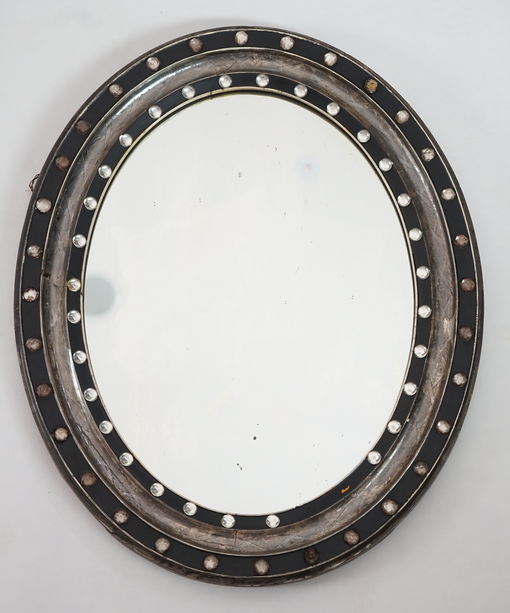 A 19th century Irish ebonised and silvered frame oval wall mirror